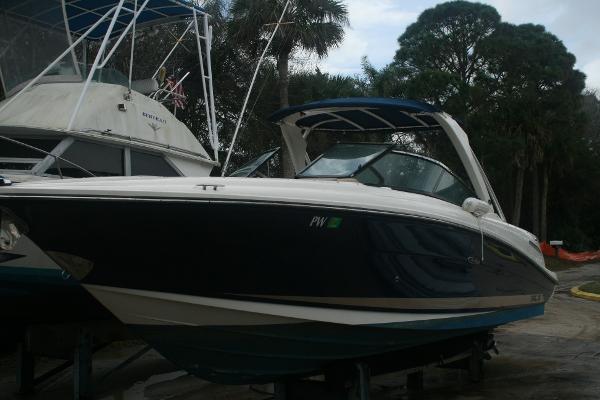 Sea Ray 270 SLX 2014 Sea Ray 270 SLX boat docked on land with trees in the background.