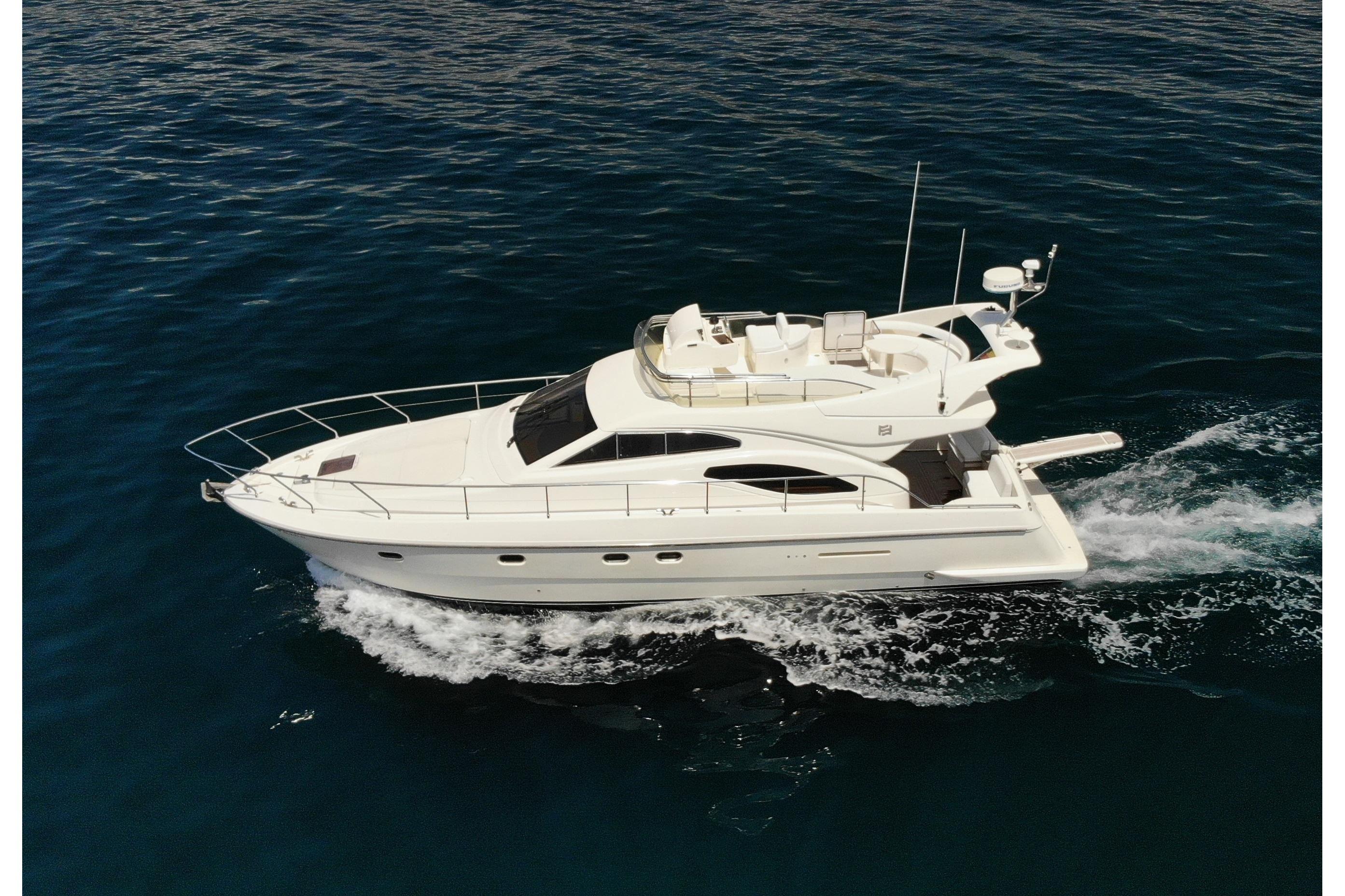 Ferretti Yachts 430 2002 FERETTI 430 yacht cruising on open water, aerial view.
