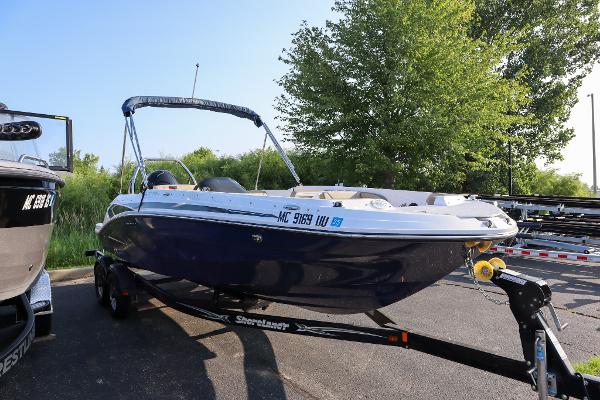 Hurricane SunDeck Sport 205 OB 2022 Hurricane SunDeck Sport 205 OB boat on trailer, parked outdoors.