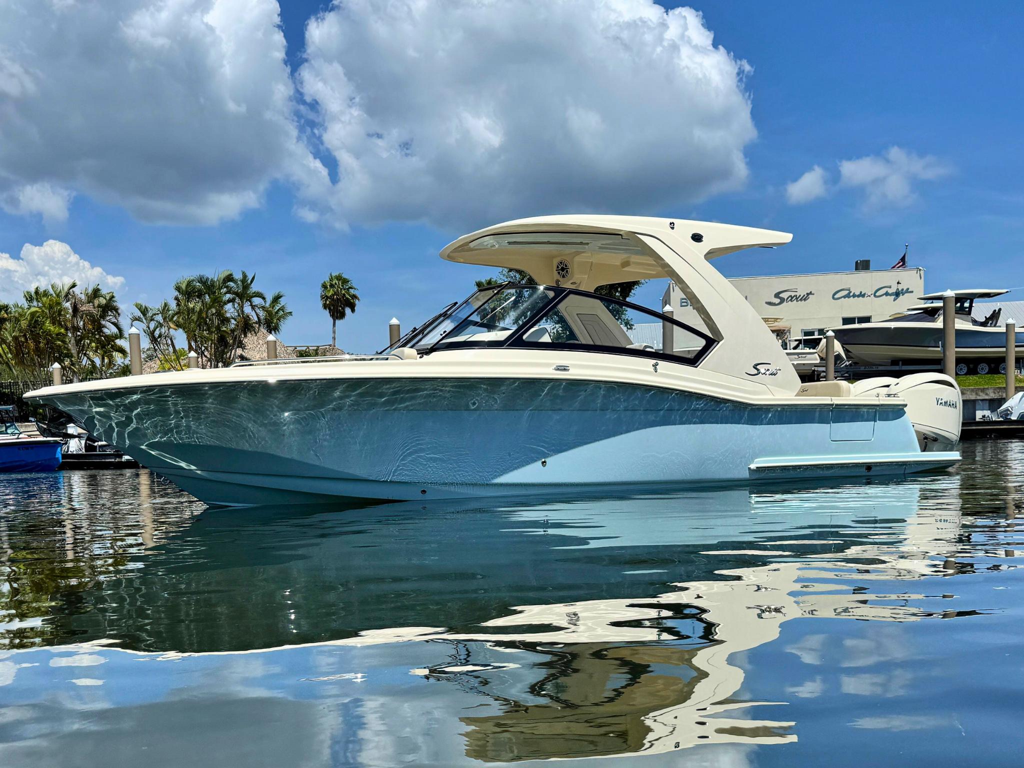 Scout 277 Dorado 2025 Scout 277 Dorado boat on calm water under a blue sky.