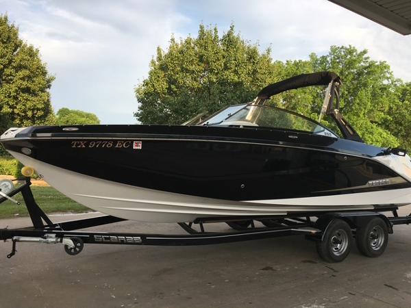 Scarab 255 2017 Scarab 255 boat on trailer, black and white design, parked outdoors.