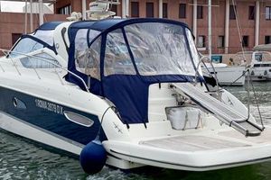 Cranchi Mediterranee 43 2008 Cranchi Mediterranee 43 yacht docked in marina, featuring blue canopy and sleek design.