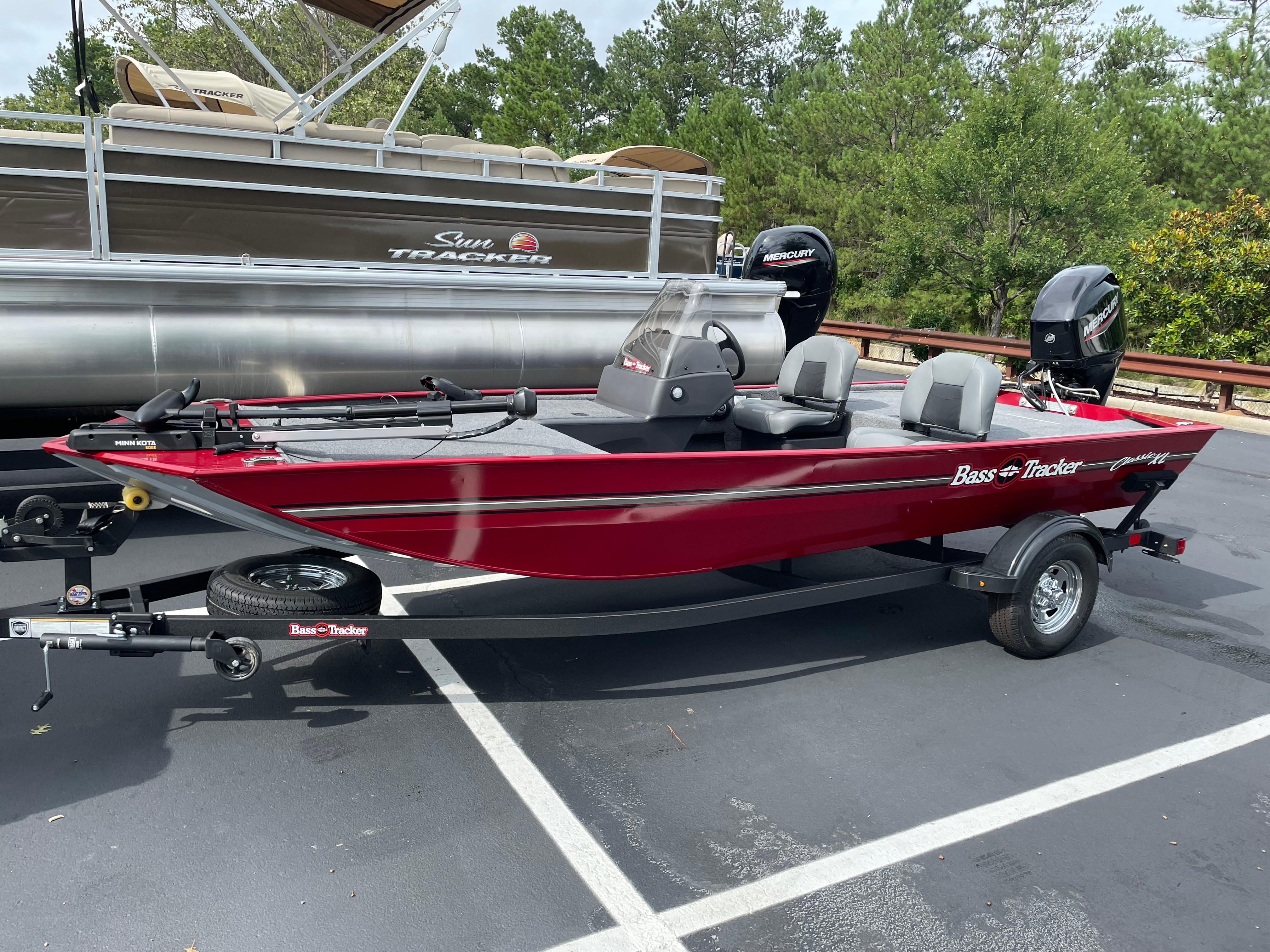 Tracker Bass Tracker Classic XL 2025 Tracker Bass Tracker Classic XL boat, red, parked on trailer in lot.
