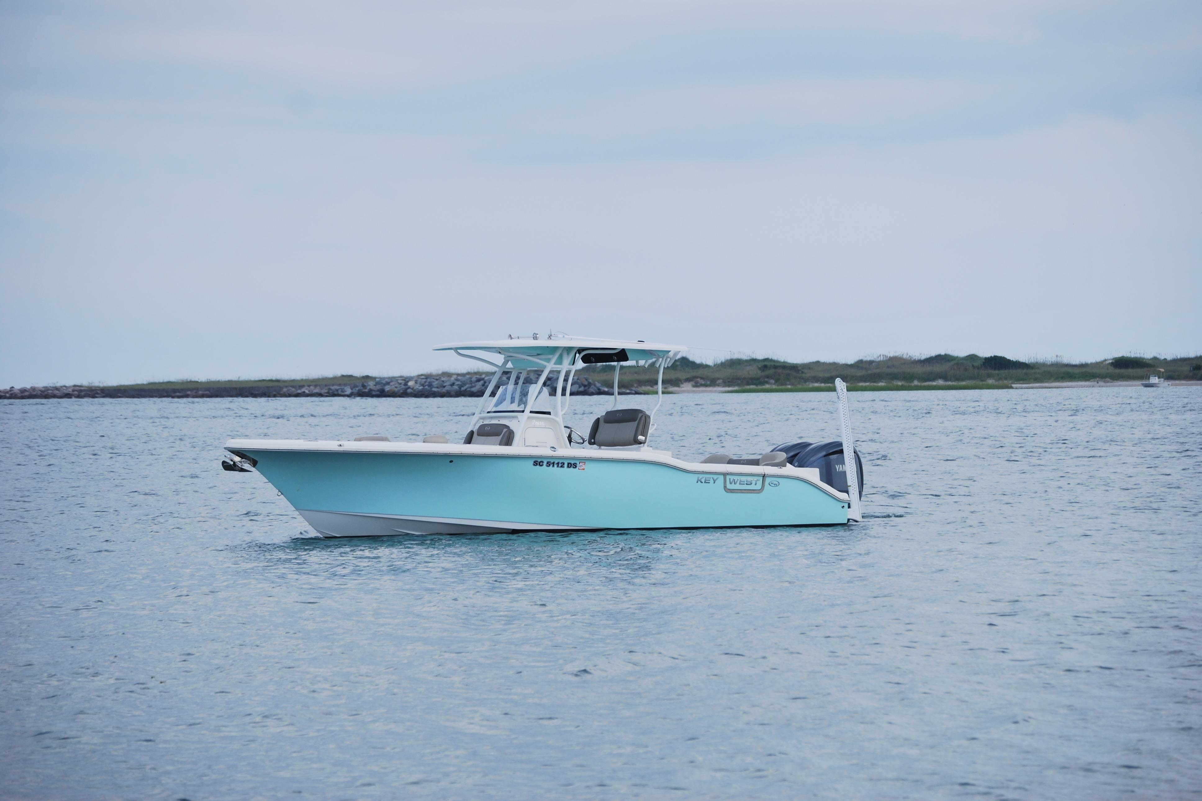 Key West 263 FS 2022 Key West 263 FS boat on calm water, overcast sky.