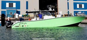 Yellowfin 42 Offshore 2016 Yellowfin 42 boat docked near a blue and gray building.