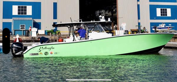 Yellowfin 42 2016 Yellowfin 42 boat docked near a blue and gray building.