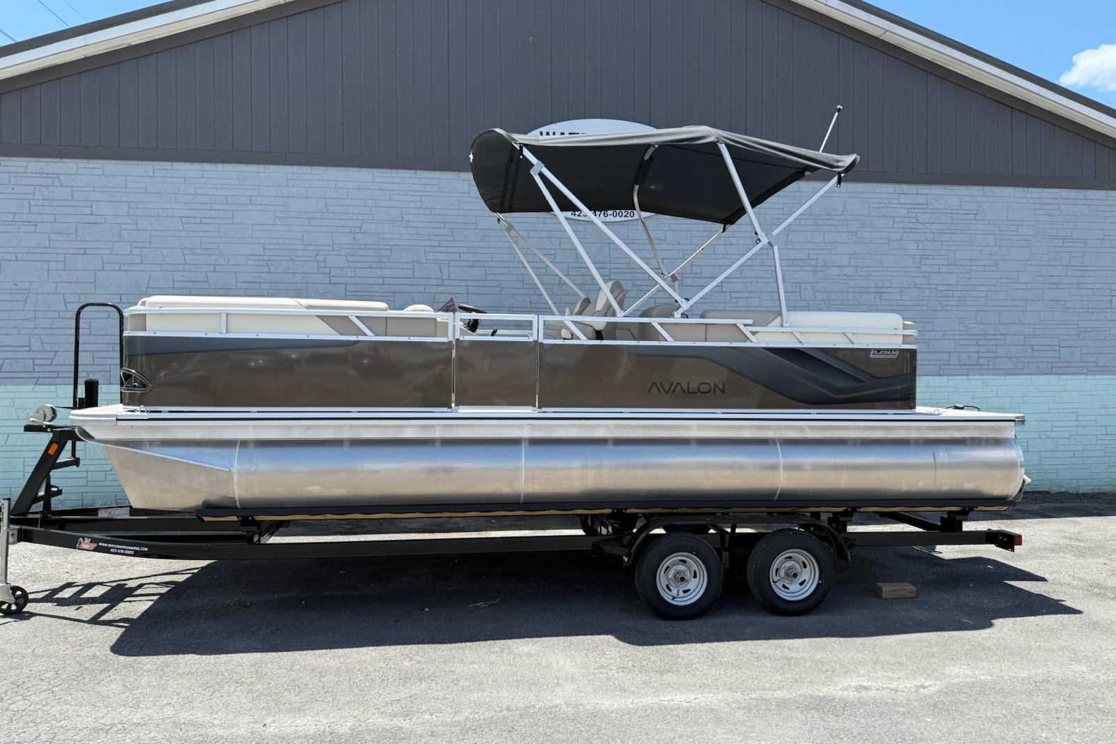 Avalon 2380 Venture Quad Lounger 2025 Avalon 2380 Venture Quad Lounger pontoon boat on trailer, side view.