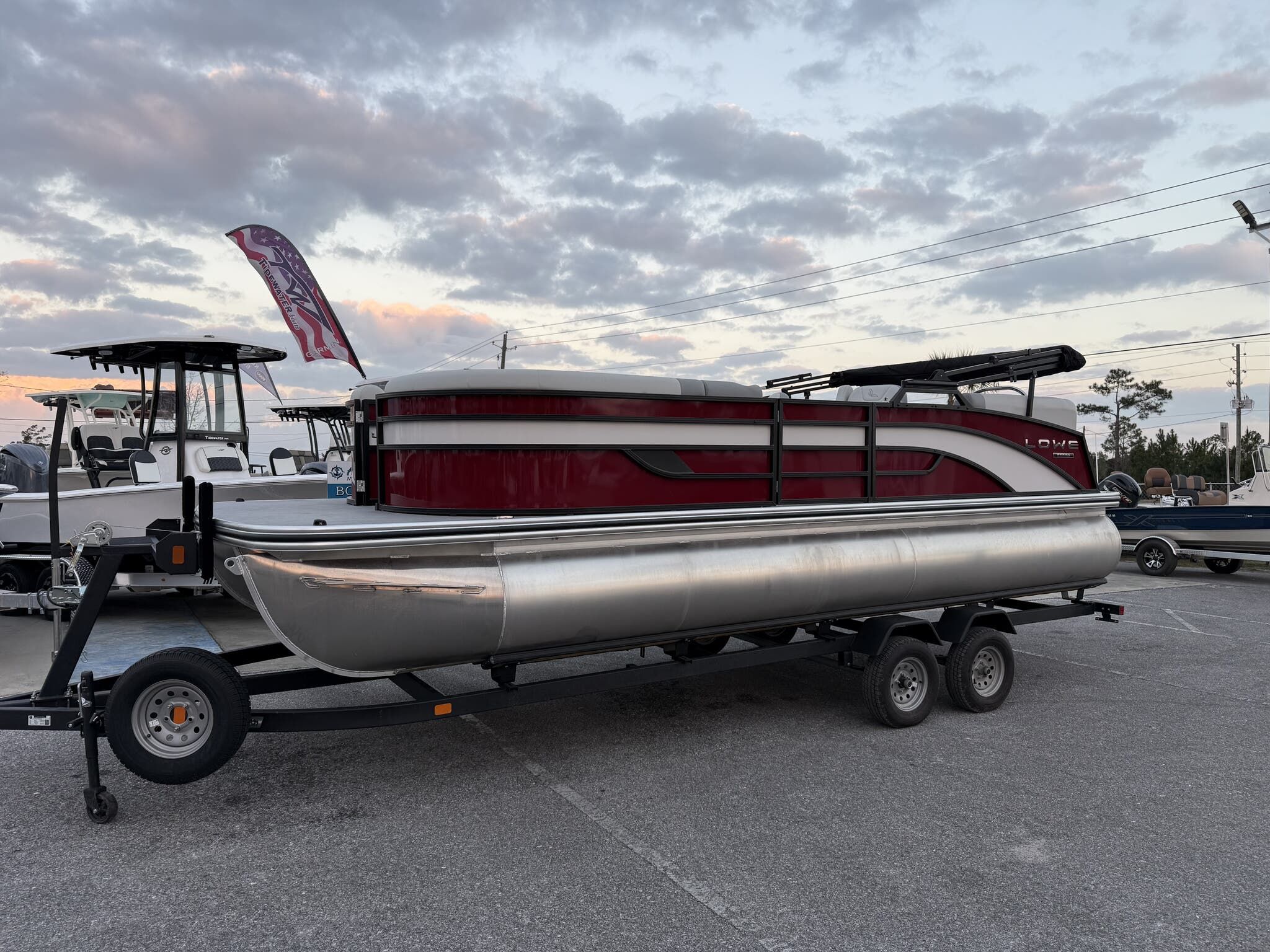 Lowe Ss 230 2026 Lowe SS230 pontoon boat on trailer at sunset.