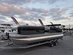 Lowe SS230 LWC00373G526 2026 Lowe SS230 pontoon boat on trailer at sunset, dealership setting.