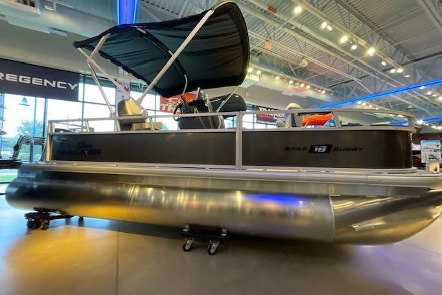 Sun Tracker Bass Buggy 18 DLX 2026 Sun Tracker Bass Buggy 18 DLX pontoon boat displayed indoors with canopy.