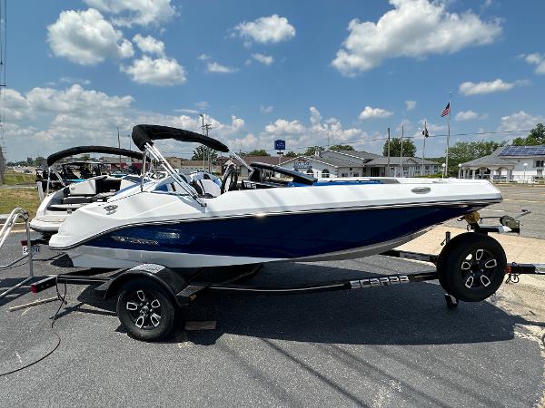 Scarab SBI165 2023 Scarab SBI165 boat on trailer under clear sky.
