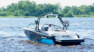 Monterey 238SS Super Sport 2016 Monterey 238 Super Sport boat cruising on a lake with lush green trees.