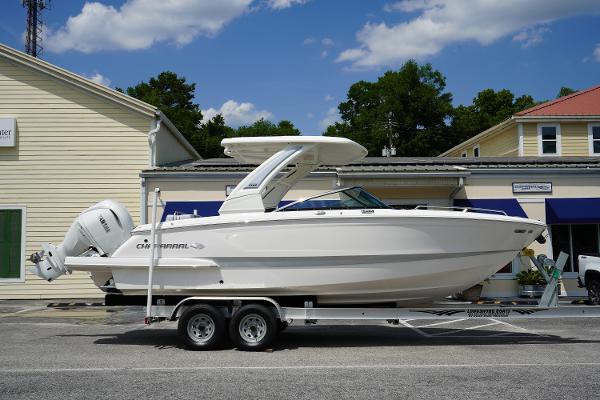 Chaparral 270 OSX 2025 Chaparral 270 OSX boat on trailer, parked outdoors under blue sky.