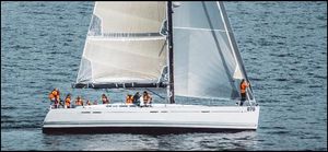 Beneteau First 50 Sailing on a 2007 Beneteau First 50 yacht with crew in orange vests.