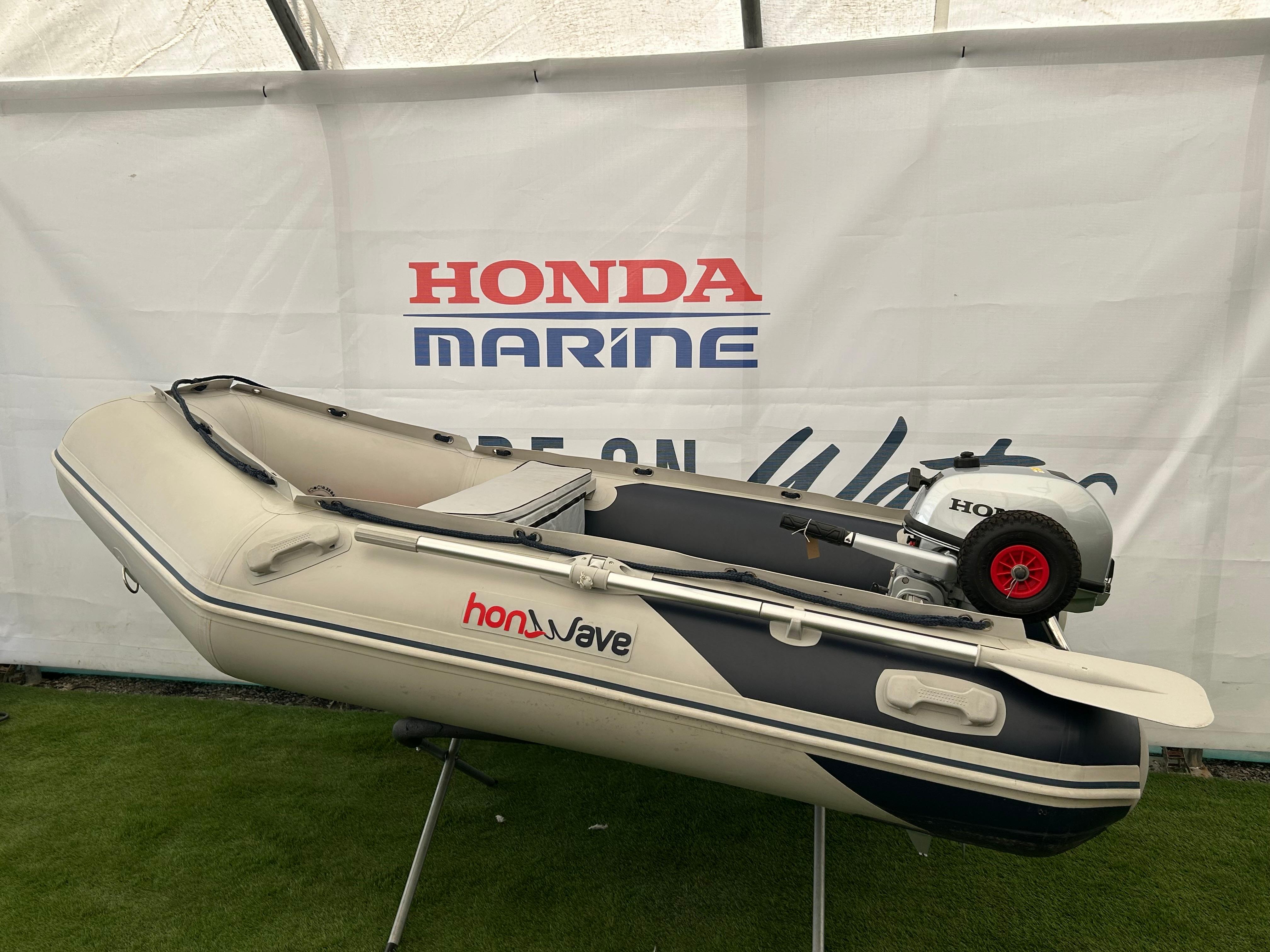 Honwave 2.7IE & BF5 SHU 2020 Honwave 2.7IE inflatable boat with Honda BF5 SHU outboard motor displayed indoors.
