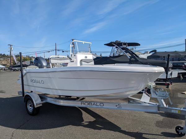 Robalo R160 Center Console 2025 Robalo R160 boat on trailer under clear blue sky.