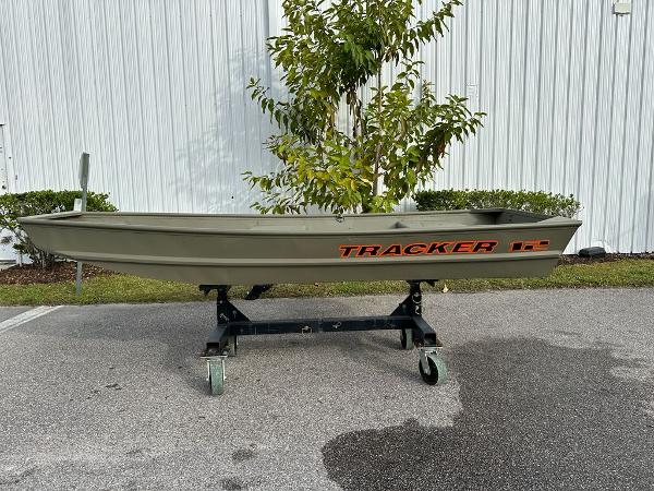 Tracker Grizzly 1236 Utility 2025 Tracker Grizzly 1236 Utility boat on wheeled stand, outdoors.