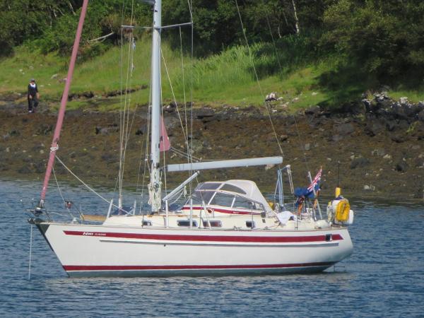 Najad 361 Sailboat Najad 361, 1997 model, anchored near a rocky shoreline with lush greenery.