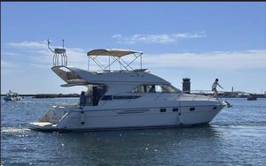 Viking Princess 46 Flybridge Sport Cruiser 1998 Viking Princess 46 Flybridge Sport Cruiser on calm water, sunny day, lighthouse in background.