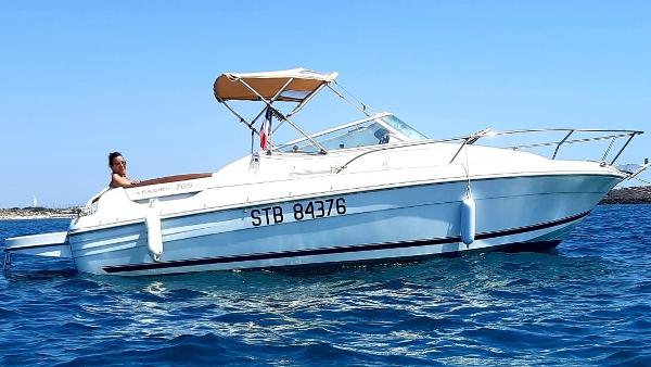 Jeanneau Leader 705 2003 Jeanneau Leader 705 boat on clear blue water with a person relaxing onboard.