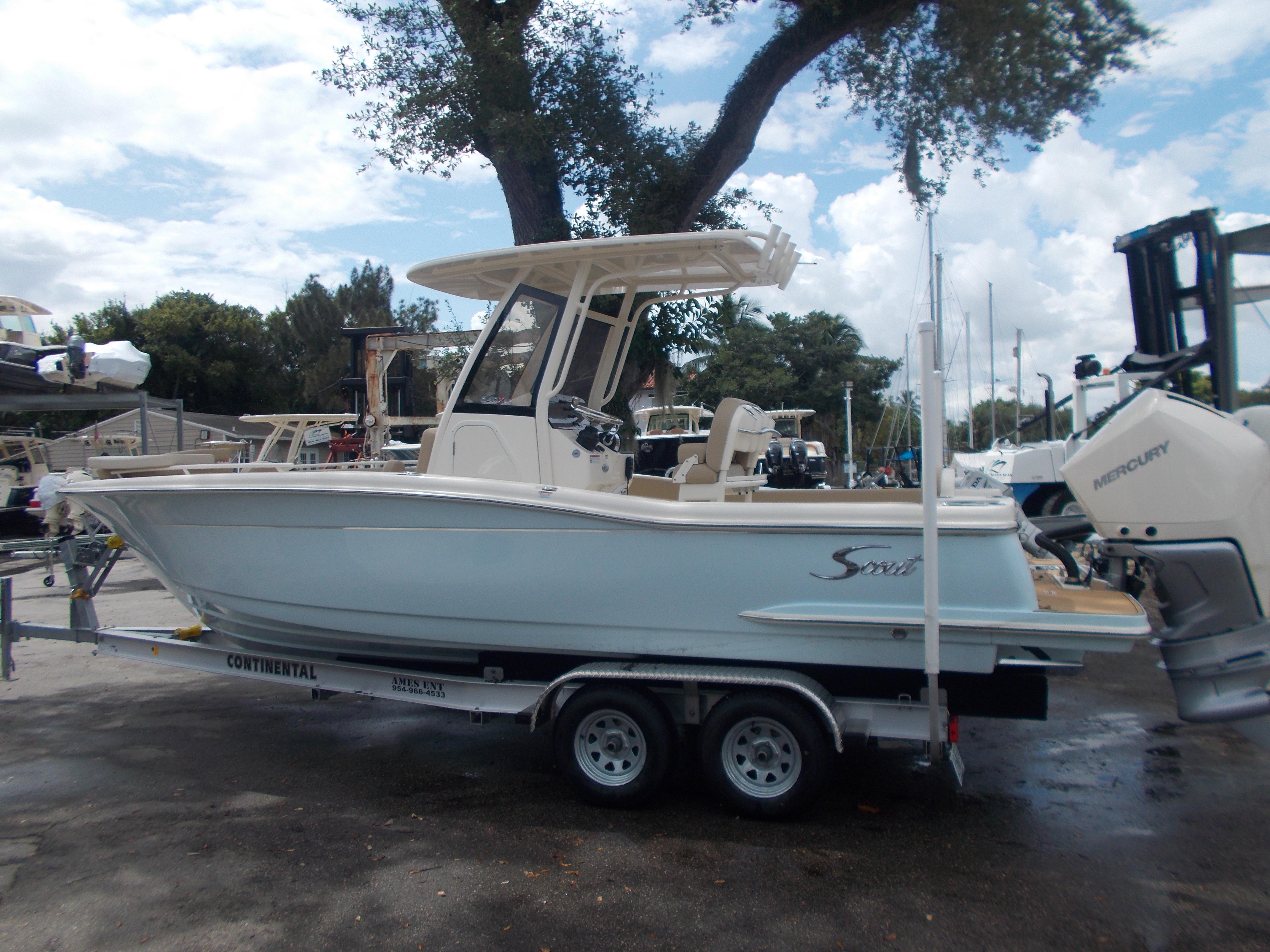 Scout 240 XSF 2025 Scout 240 XSF boat on a trailer in a marina.