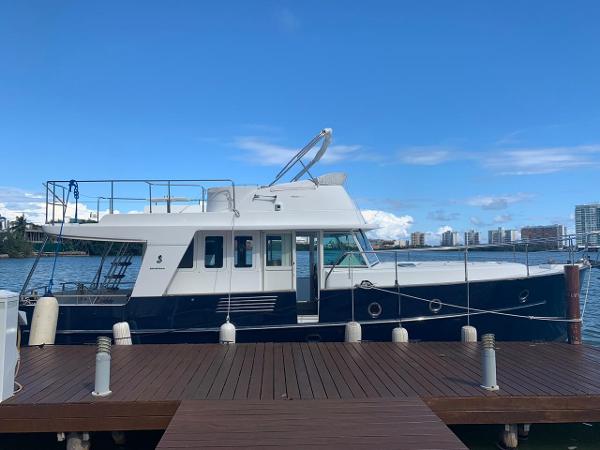 Beneteau Swift Trawler 42 2006 Beneteau Swift Trawler 42 docked, blue and white exterior, city skyline in background.