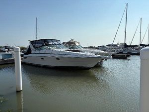 Trojan 40 Express Cruiser 2000 Trojan 40 Express Cruiser docked in a marina, surrounded by other boats.