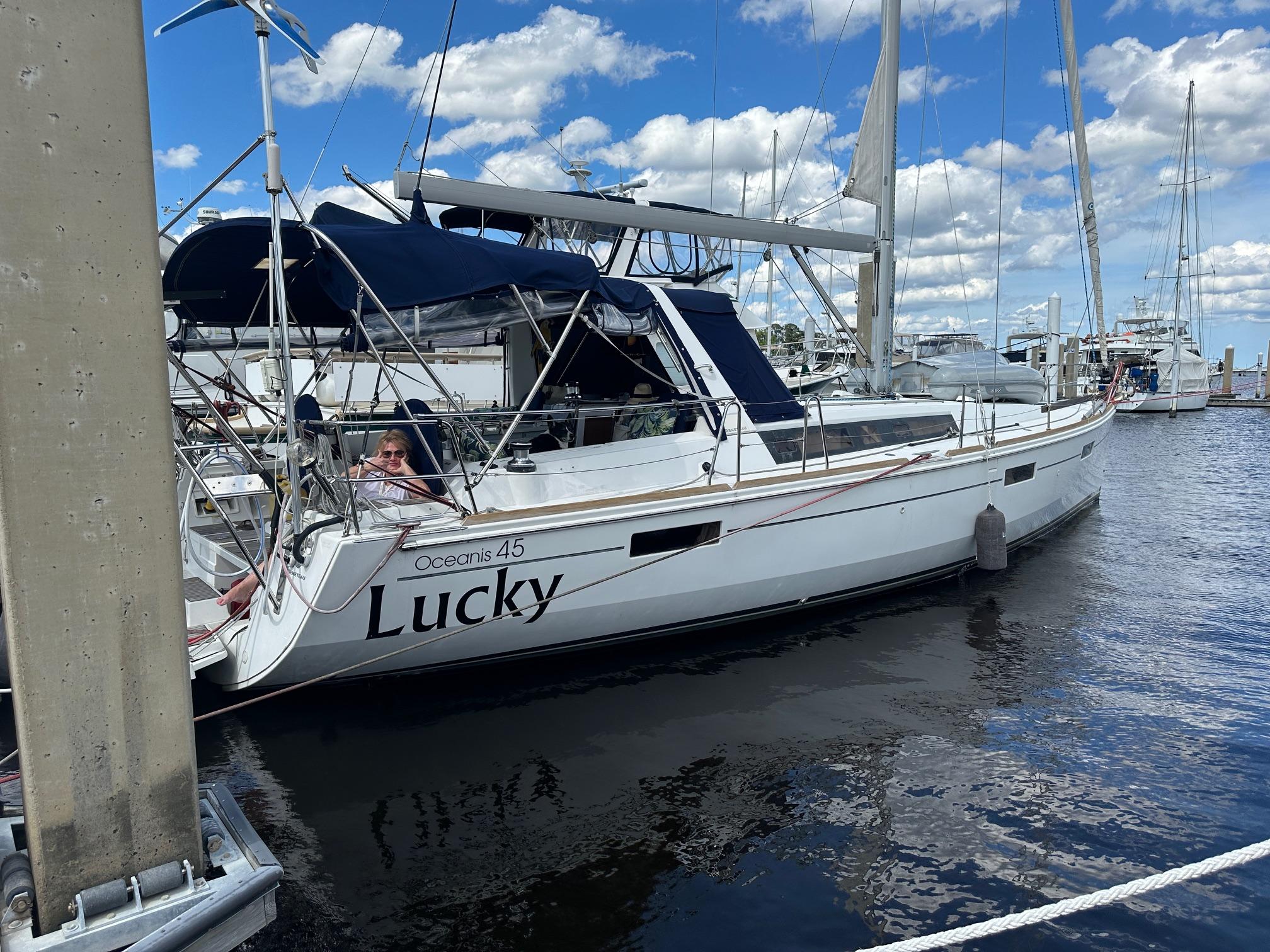 Beneteau Oceanis 45 2014 Beneteau Oceanis 45 sailboat named "Lucky" docked at a marina under a blue sky.