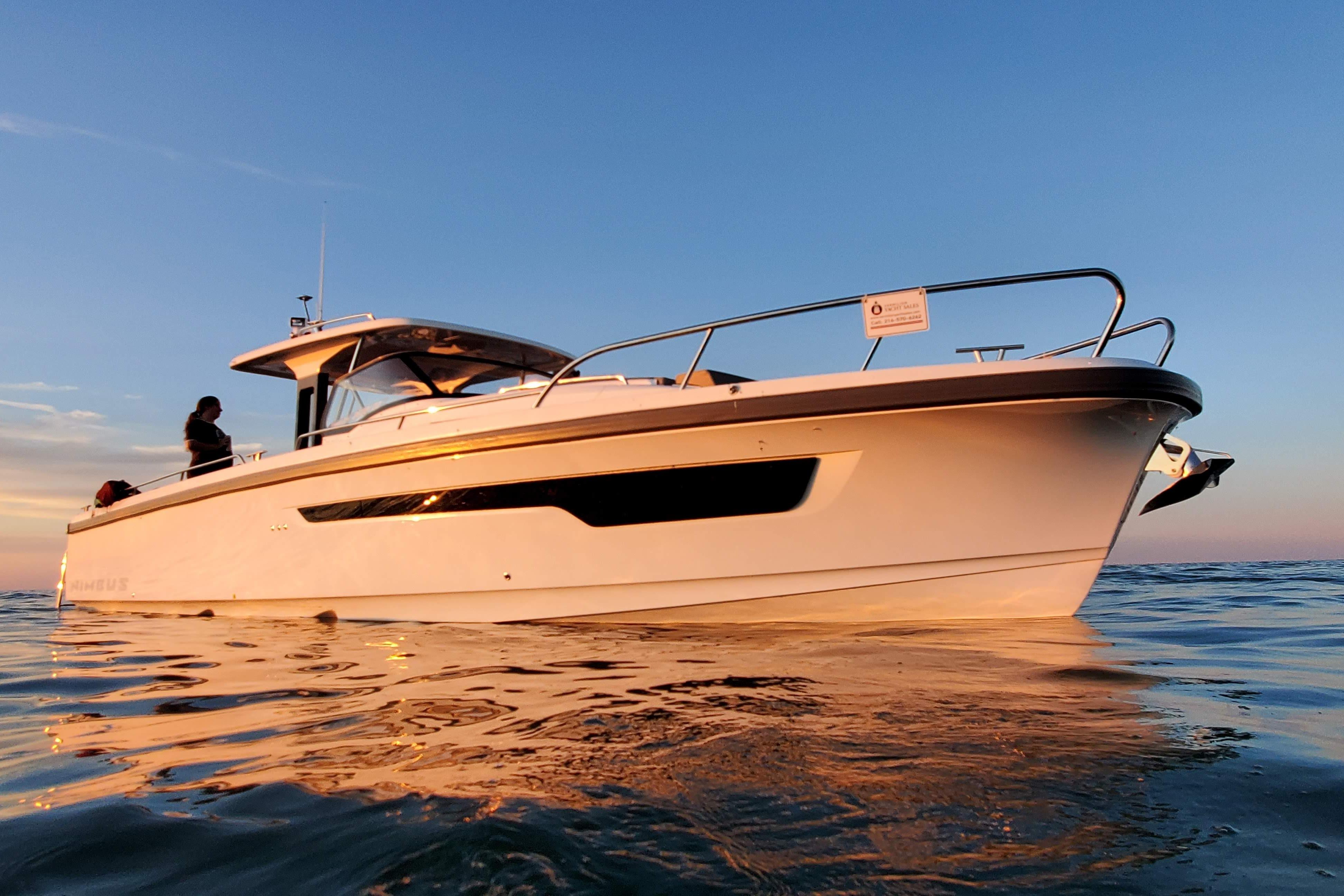 Nimbus T11 2022 Nimbus T-11 boat on calm water at sunset.