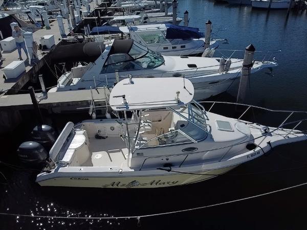 Cobia 250 Walk-Around 2006 Cobia 250 Walk-Around boat docked in a marina, featuring twin engines.