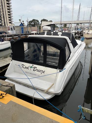 Sea Ray 350 Sundancer 1991 Sea Ray 350 Sundancer docked, named "Kool Breeze," with black canopy in marina setting.