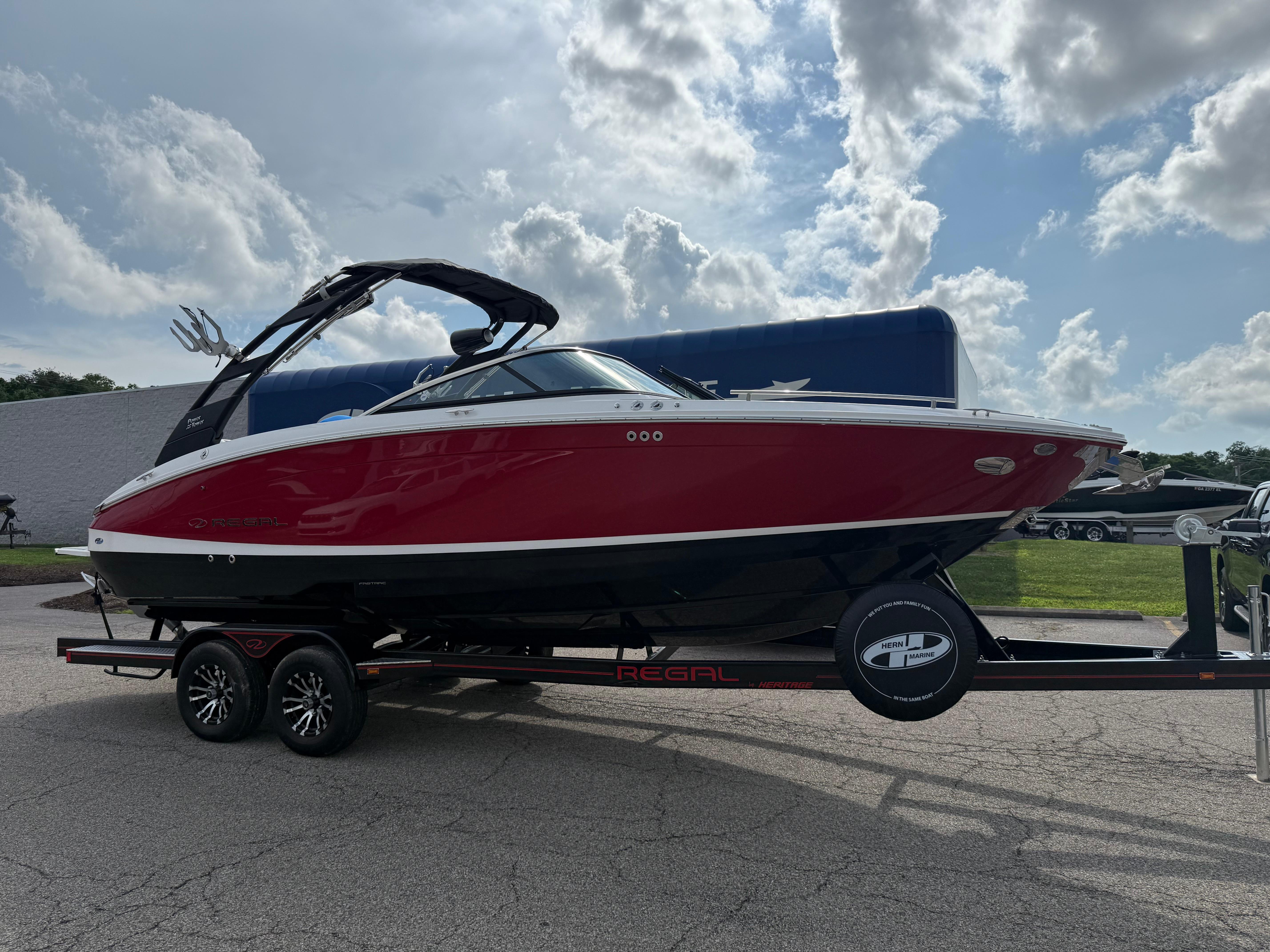Regal LS6 Surf 2025 Regal LS6 Surf boat on trailer under cloudy sky.
