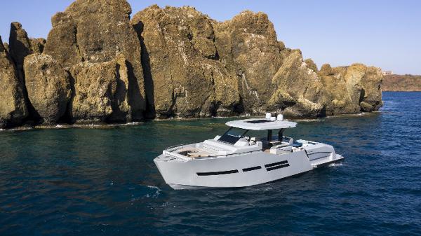 Mazu Yachts 62 2025 Mazu Yachts 62 cruising near rocky coastline.