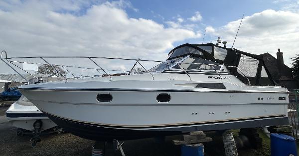 Princess 286 Riviera 1989 Princess 286 Riviera boat with sleek design, docked outdoors under a cloudy sky.
