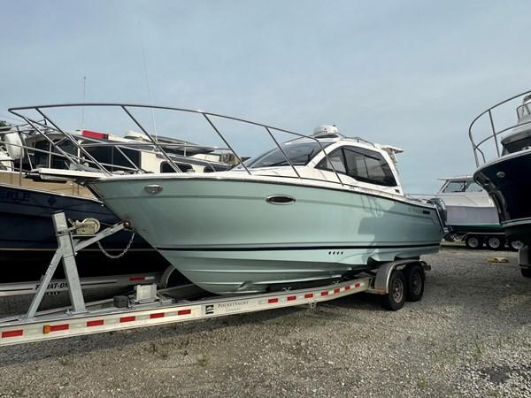 Cutwater C-24 2017 Cutwater C-24 boat on trailer, parked outdoors, side view.