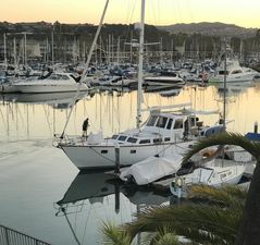 Maple Leaf 56 Sailboats docked at a marina during sunset, featuring a 1979 Maple Leaf 56 yacht.