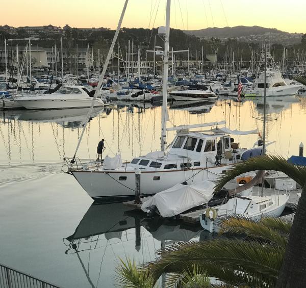 Maple Leaf 56 Sailboats docked at a marina during sunset, featuring a 1979 Maple Leaf 56 yacht.