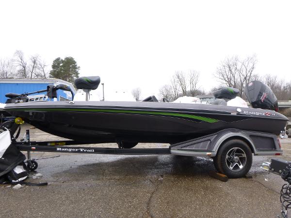Ranger Z 518 2023 Ranger Z518 boat on trailer, black with green accents, parked outdoors.