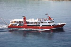 Boatyard Passenger Boat Red and white Boatyard passenger boat cruising on calm water, 2002 model.