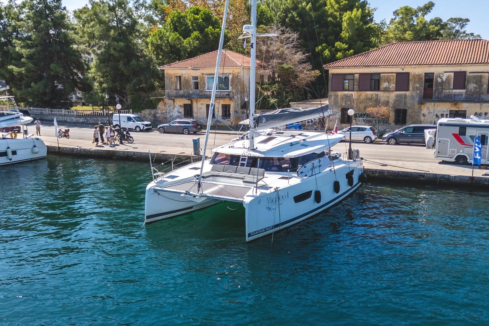 Fountaine Pajot Astrea 42 Maestro 2023 Fountaine Pajot Astrea 42 Maestro catamaran docked by a scenic waterfront.