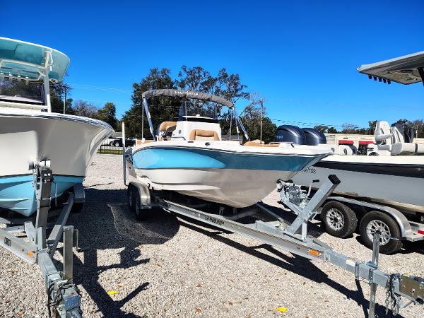 NauticStar 211 Hybrid 2024 NauticStar 211 Hybrid boat on trailer, displayed outdoors under clear blue sky.