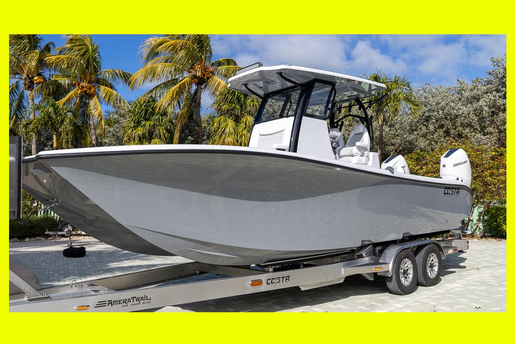 Costa Custom Boats 264 HC 2025 Costa Custom Boats 264 HC on trailer, surrounded by palm trees, under clear blue sky.