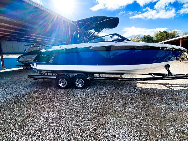 Cobalt R8 Surf 2023 Cobalt R8 Surf boat on trailer under sunny sky.