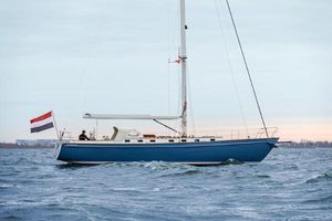 Hutting 46 Sailing yacht Hutting 46, 2023 model, cruising on open water with a flag.