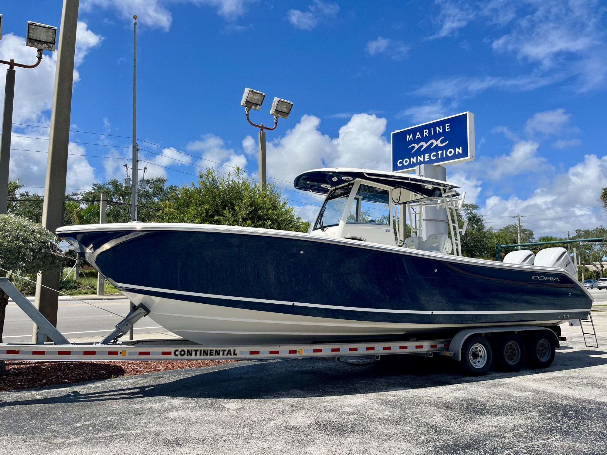 Cobia 320 Center Console 2025 Cobia 320 Center Console boat on trailer at Marine Connection dealership.