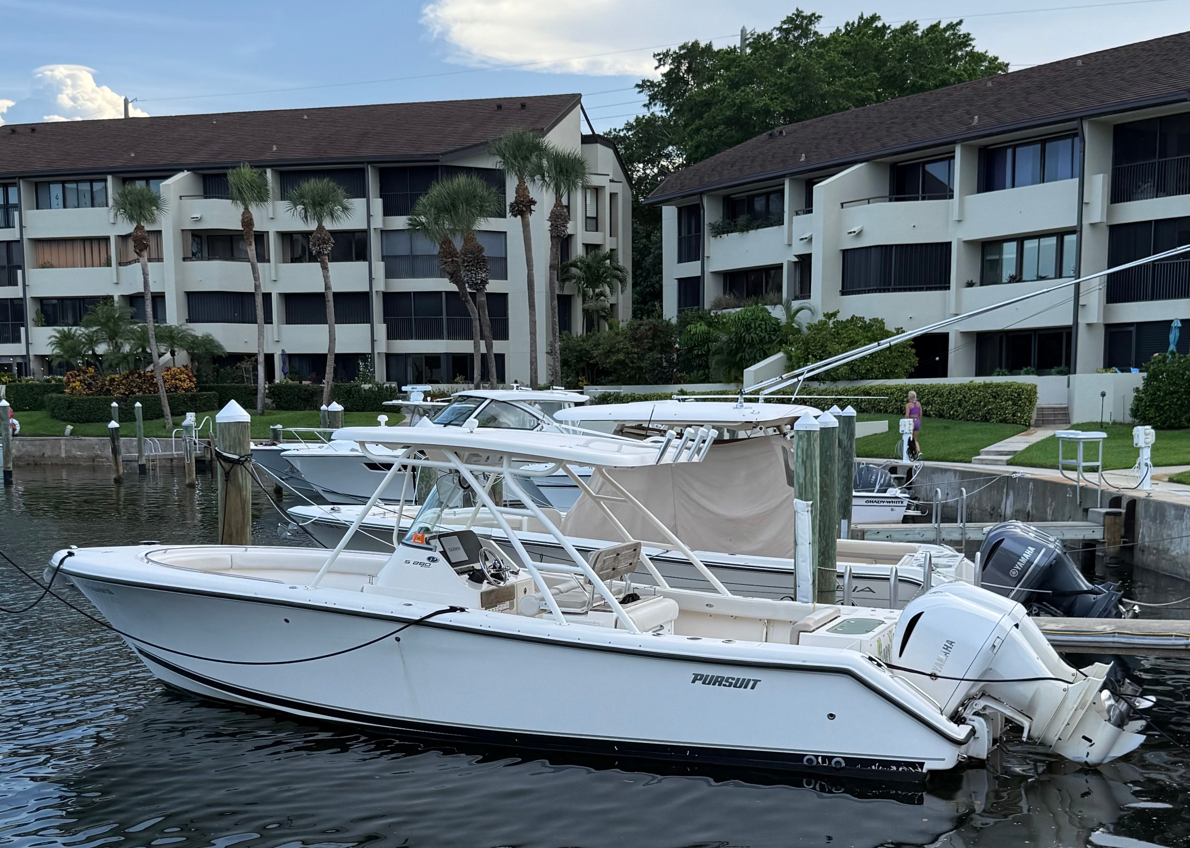 Pursuit S 280 Sport 2019 Pursuit S280 boat docked near waterfront apartments.