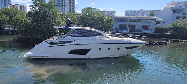 Azimut Atlantis 44 2013 Azimut Atlantis 44 yacht cruising near waterfront homes and lush greenery.