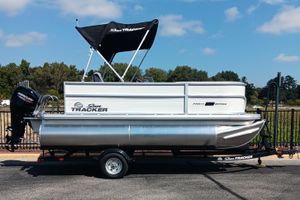 Sun Tracker Party Barge 16 DLX 2026 Sun Tracker Party Barge 16 DLX pontoon boat on trailer, outdoors.
