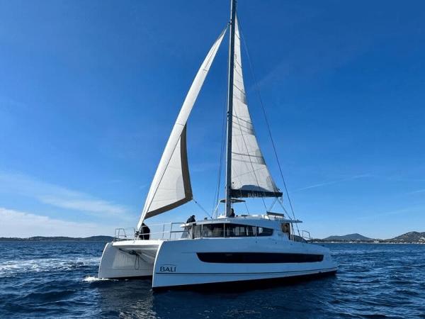 Bali 4.2 2023 Bali 4.2 catamaran sailing on open sea under clear blue sky.