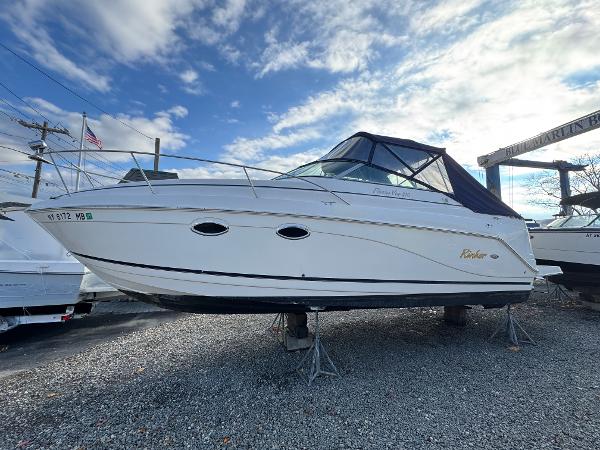 Rinker 270 Fiesta Vee 2005 Rinker 270 Fiesta Vee boat on stands, under a partly cloudy sky.